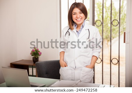 Portrait of a gorgeous female doctor in a lab coat waiting for her next patient at her office