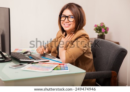 Portrait of a beautiful graphic designer enjoying her work and smiling