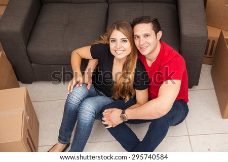 High angle view of an attractive young couple unpacking their stuff in their new home