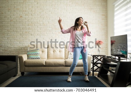 Similar – Image, Stock Photo Young woman singing with a microphone