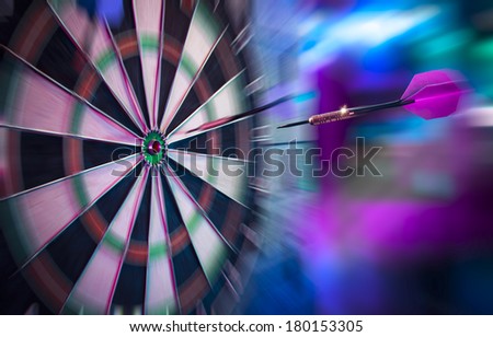dartboard on a brick wall about to get hit by dart