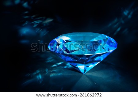 luxurious blue diamond shining on a black background