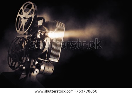 Movie projector on a dark background with light beam / high contrast image Imagine de stoc © 