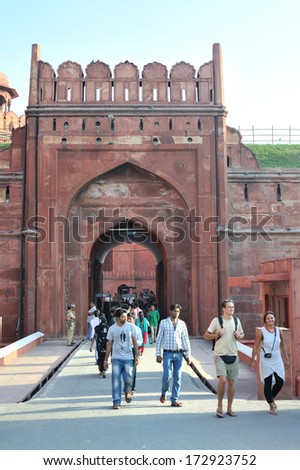 DELHI, INDIA - SEPT 18, 2013: Local and foreign tourists go in and out from the main gate of Red Fort, a famous heritage building in Delhi, India.