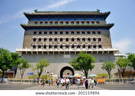 Beijing - June 8, 2014: people are crossing the road before Zhengyangmen Gate, a old Gate in the downtown of Beijing, China