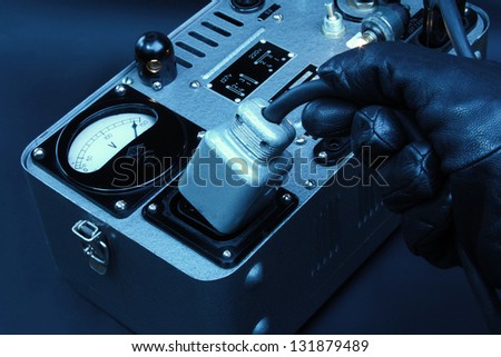 Hand pulling a big electric plug off a vintage generator