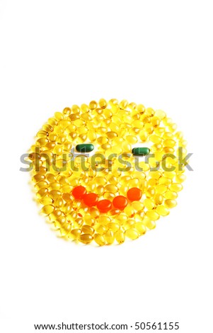 conceptual smiling round face made of yellow pills
