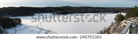 Frozen lake in Smaland, Sweden, with cracks in the ice. Seen from a hill beside the lake. Panorama made of 5 pictures.