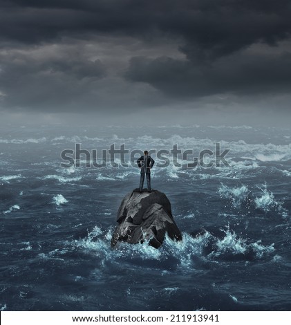Stranded businessman lost at sea standing on an isolated rock as a business concept for financial despair or being lost and needing career or financial help to escape the crisis.