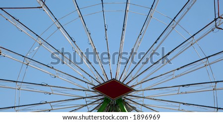 Carnival ferris wheel spokes with clear sky