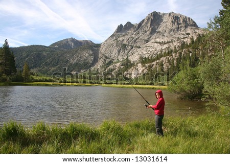 Young fisherman enjoying nature in the High Sierras of California