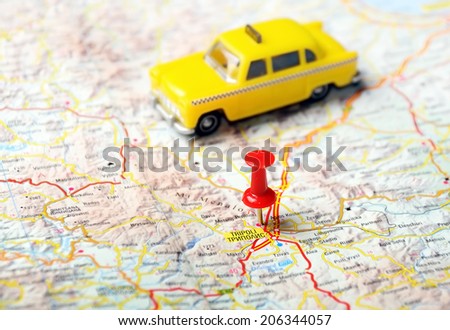 Close up of  Tripoli ,Greece  map with red pin and a taxi   - Travel concept