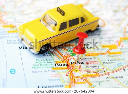 Close up of  Pisa  , Italy map with red pin and a taxi   - Travel concept
