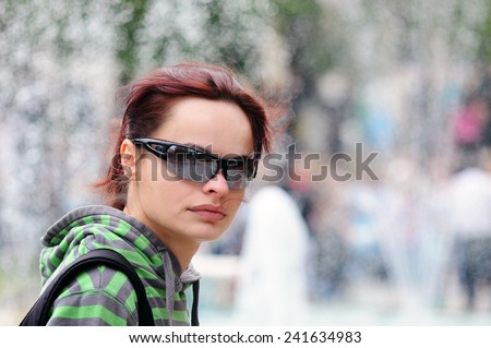 Portrait of a casual  candid   girl with sunglasses on street ,nice   bokeh
