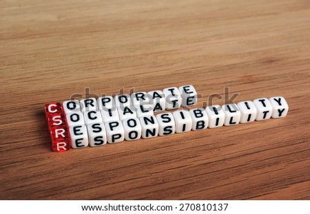 CSR Corporate Social Responsibility acronym on cubes on wood