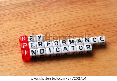 KPI Key Performance Indicator written on cubes on wooden background