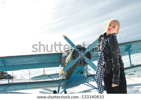 sexy young girl next to the pilot vintage aircraft