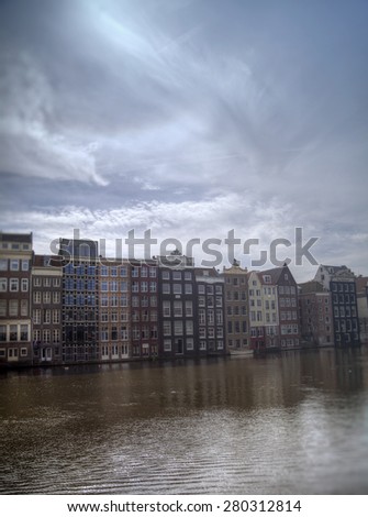 Amsterdam in the summer. long old houses hanging over the water in an authentic European city