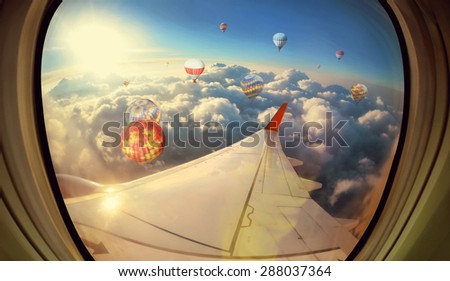 Clouds ,sky and Balloons as seen through window of an aircraft