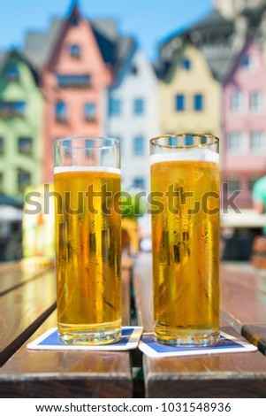 Similar – Image, Stock Photo A fresh beer (Kölsch) is tapped at the tap in a bar