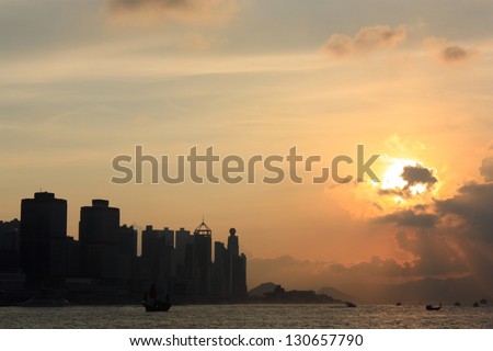 Sunset in Victoria Harbor, silhouette of Hong Kong.