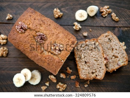 Banana and Walnut loaf cake cut open on wooden board