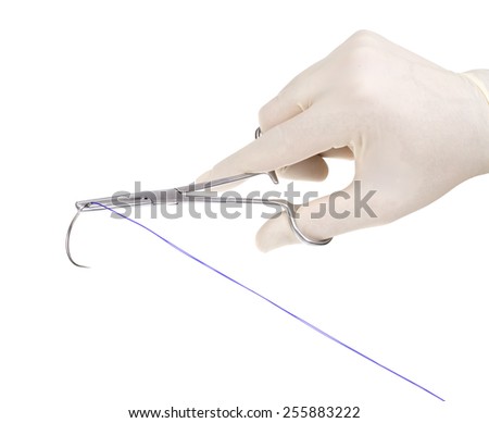 Surgical needle in the hands