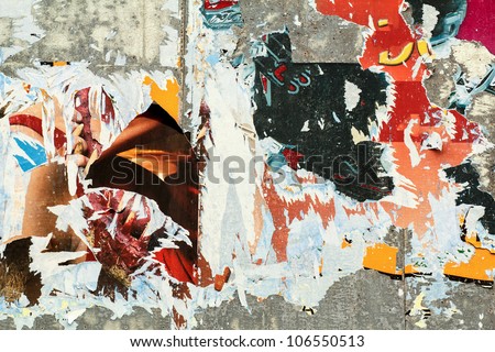 grunge background on billboard with old torn posters