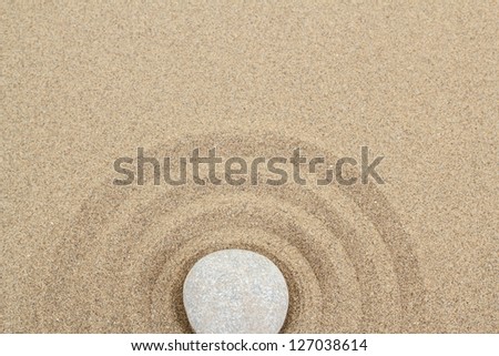 zen stones in soft sand with circles