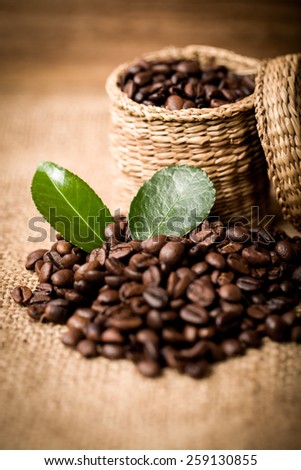 pile of coffee beans and wooden spoon in jar with space for text