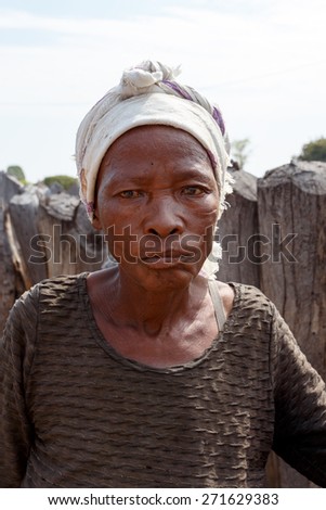 NAMIBIA, KAVANGO, OCTOBER 15: An unidentified old wrinkled woman behind gate of his village in Namibia, Kavango region, with the highest poverty level in Namibia. October 15, 2014, Namibia