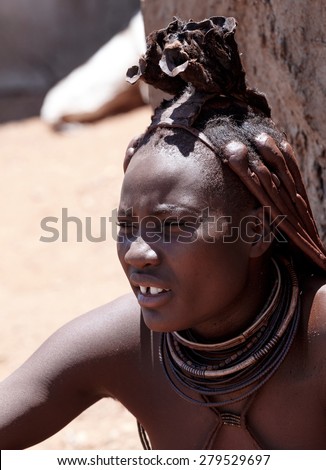 NAMIBIA, KAMANJAB, OCTOBER 10: Himba tribe woman with ornaments on the neck, in the village of Himba people near Kamanjab in northern Namibia, October 10, 2014, Namibia