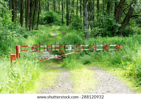 barrier gate on rural path with forest background usage