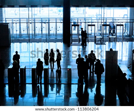 Entrance to modern building and people silhouettes
