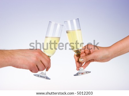 Two wine glasses toasting