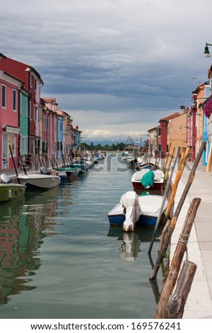 A series of beautiful colored houses on the river channel. Island Burano (Venice, Italy)