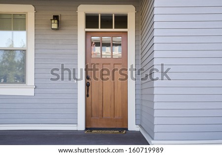Closed wooden front door of a house during daytime