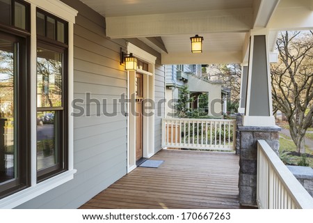 Horizontal Shot of wrap around porch on an upscale home/Large Porch Exterior of an Upscale Home