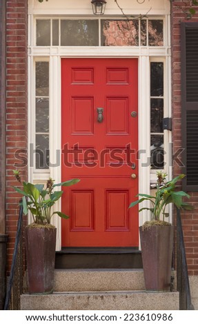Red Front Door in White Door Frame with Windows and Plants