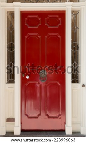 Red Front Door with White Door Frame and Surrounding Windows