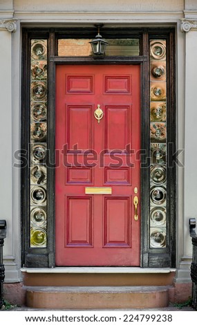 Red Front Door with Surrounding Black Door Frame and Bulls Eye Glass