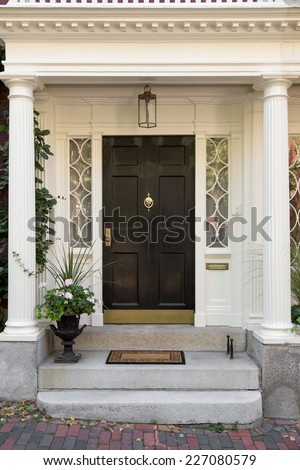 Black Front Door with White Door Frame and Side Windows over Steps with Potted Plant