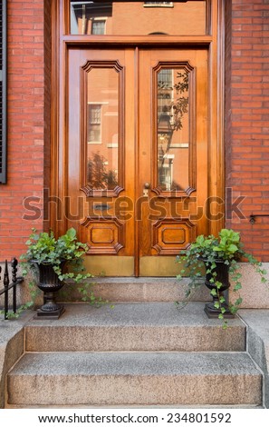 Natural Wood Double Front Doors with Inset Windows and Greenery