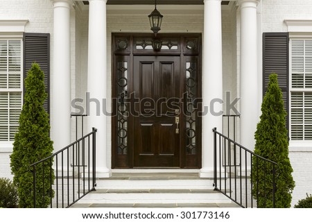 Entrance to traditional style home with black front door.