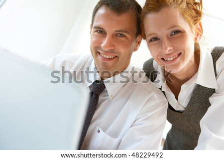 young man and women working with laptop