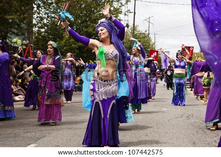 SEATTLE, WA - JUNE 16, 2012: Members of the Silk Road Performance Troupe belly dancing during the Fremont Summer Solstice Parade in Seattle on June 16, 2012. The parade celebrates the start of summer.