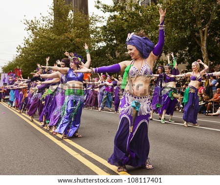 SEATTLE, WA - JUNE 16, 2012: A line of belly dancers in the Silk Road Troupe dance during the Fremont Summer Solstice Day Parade in Seattle on June 16, 2012. The parade celebrates the start of summer.