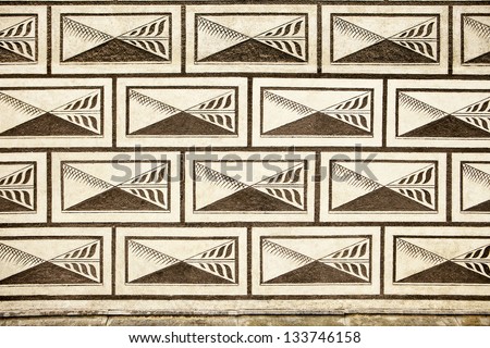 A geometric repeating pattern is painted on the stone wall of a Czech palace in Prague to provide a sense of scale and perspective.