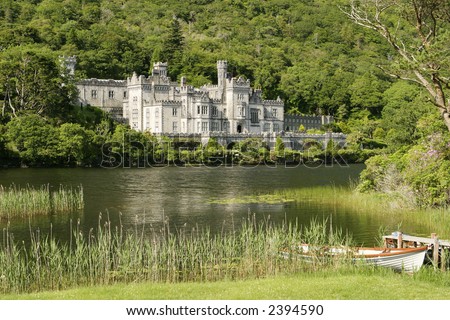 An Irish castle in the countryside. Located next to a lake, this was originally the residence for Irish nobility and is now a convent and girls\' school. The white skiff in the foreground is common.