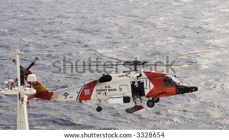 A helicopter rescue mission. This was not a drill as a cruise ship\'s passenger was being evacuated on a stretcher as a crewman reaches out.